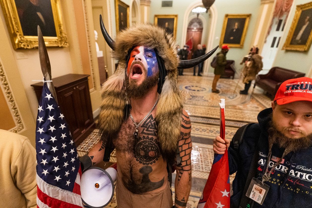 <p>Jake Angeli, Self Initiated Shaman, Energetic Healer, Ordained Minister, ‘Yellowstone Wolf'’ and pro QAnon protester at US Senate 6 January 2021. Source Manuel Balce Ceneta / Associated Press</p>