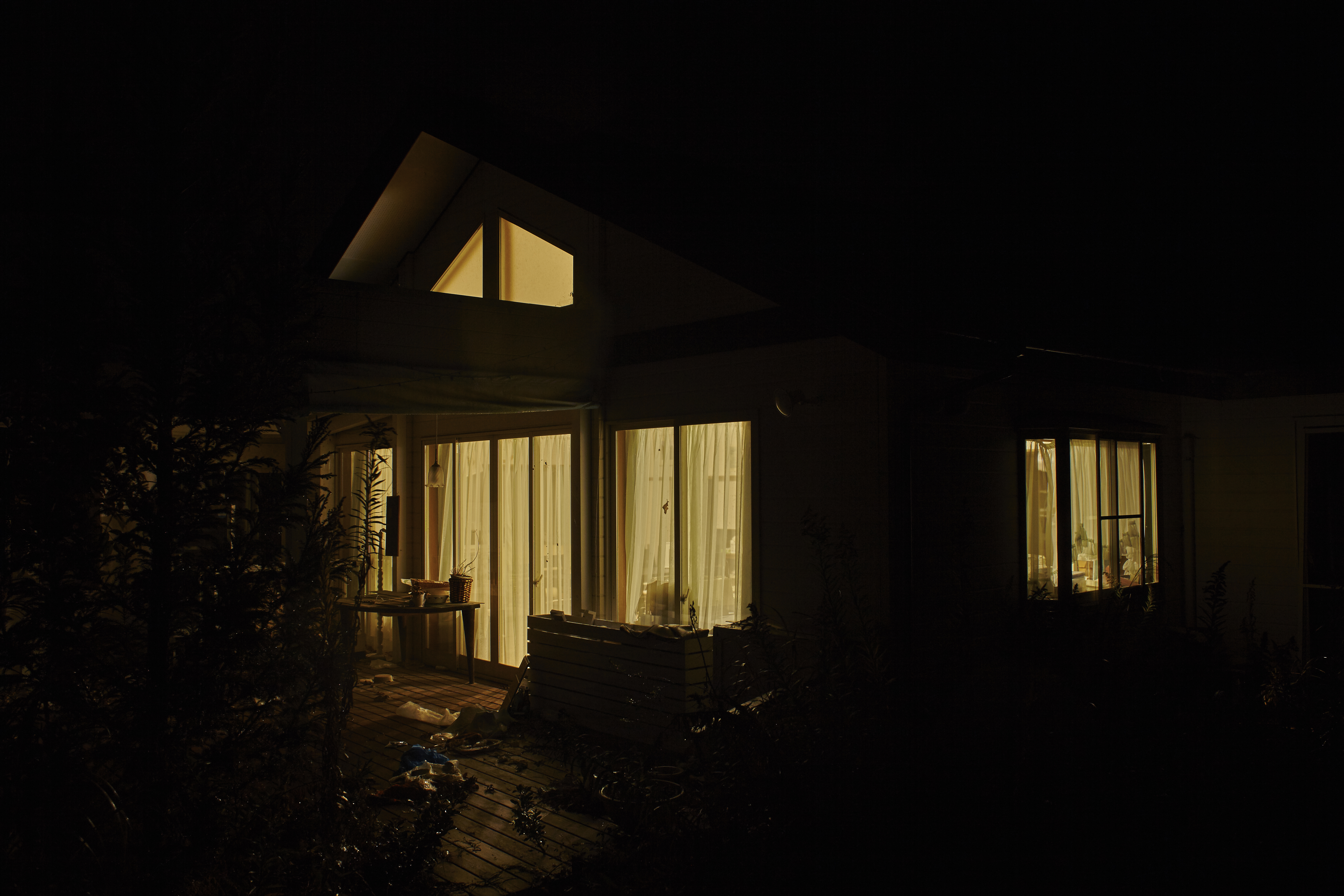 <p>The house on site with lights on at night that is Ai Weiwei’s work, A Ray of Hope (2015). Courtesy Don’t Follow the Wind</p>